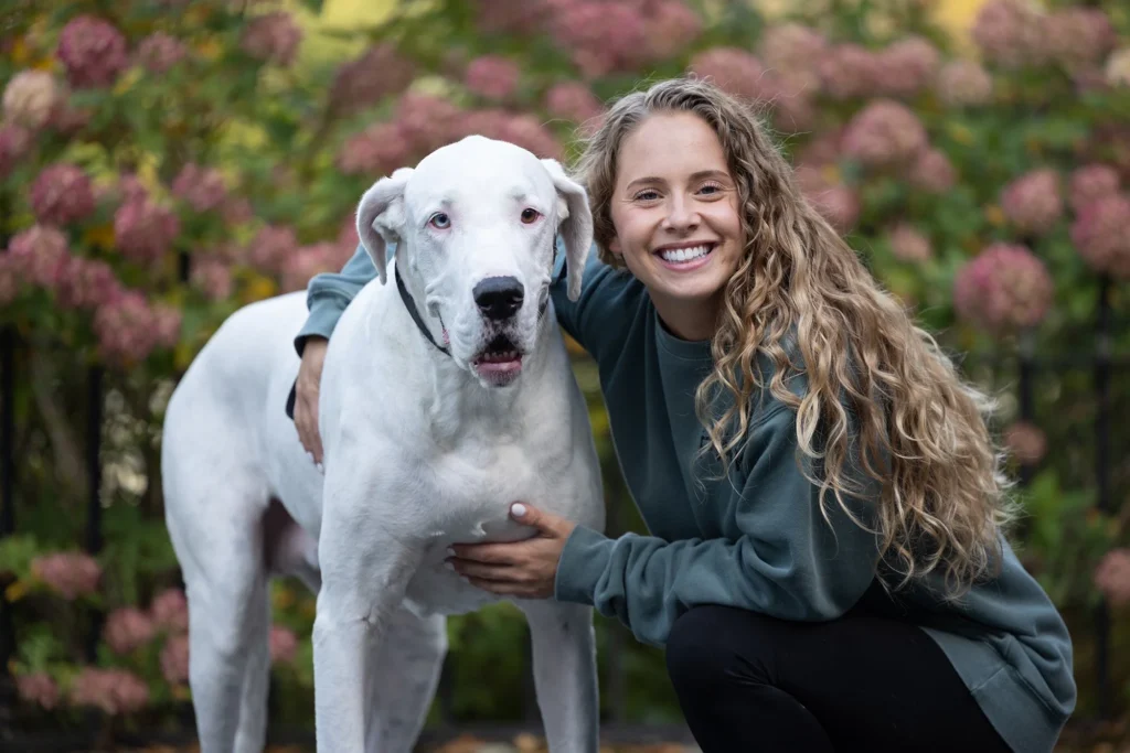great dane with her owner in a garden at endicott park