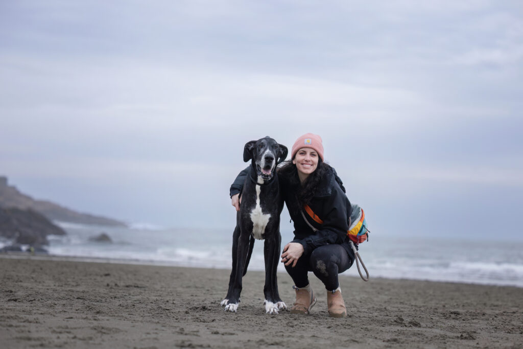 Dog owner and her Great Dane smiling together at Good Harbor Beach, Gloucester